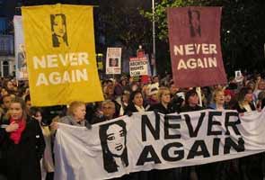 Some of the thousands who marched in Dublin on Saturday in memory of Savita Halappanavar Protestors marching in Dublin with pictures of Savita Halappanavar and the slogan "Never Again"