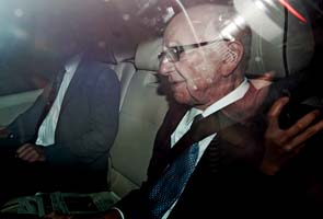 Murdoch's car mobbed by photographers near Parliament