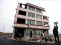 Home amid Chinese highway a symbol of resistance